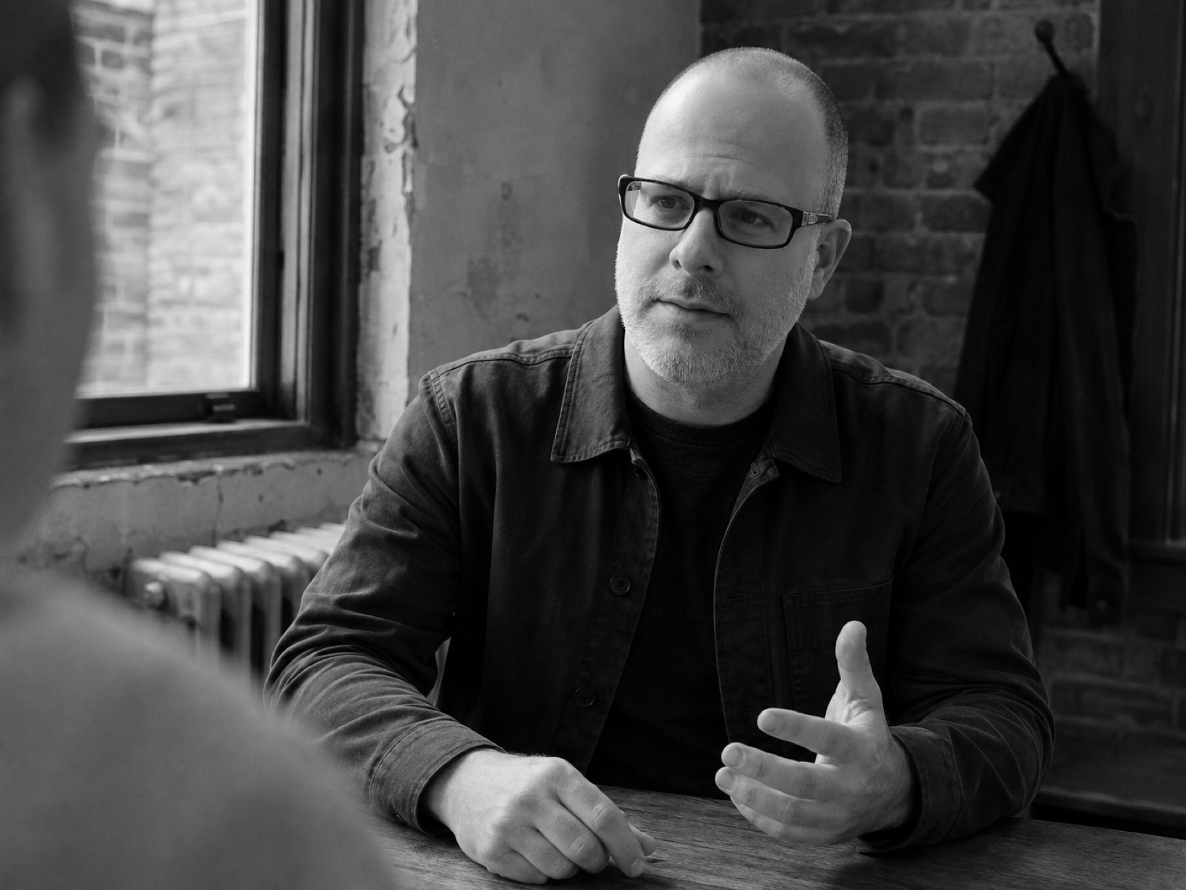 Steve Ice across a table, in conversation