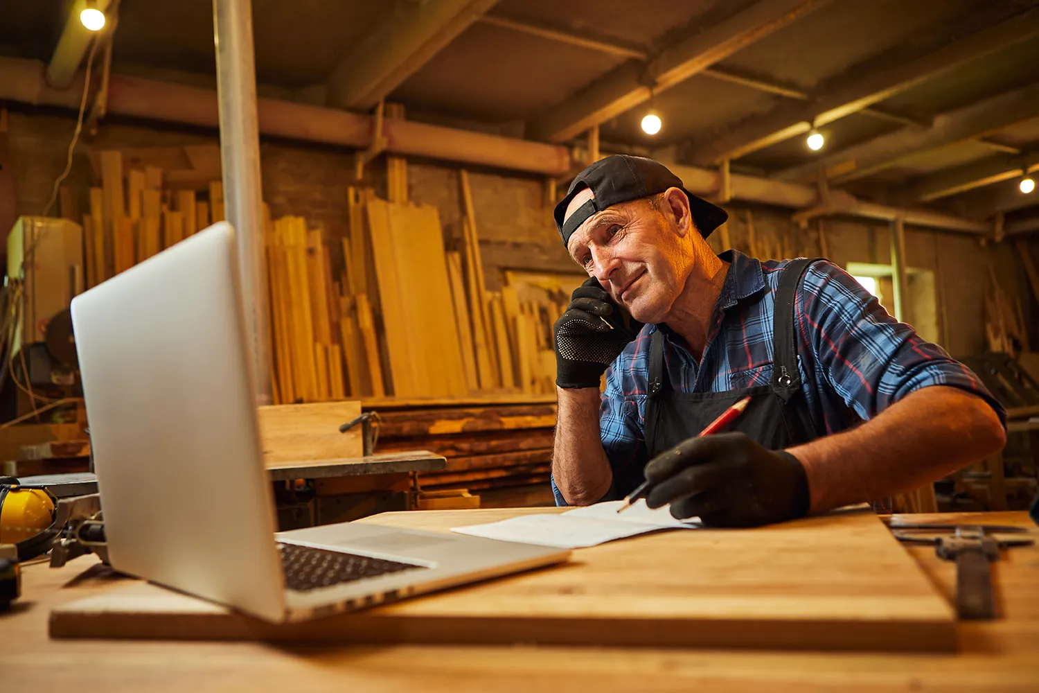 Small business owner reviewing online marketing plans in a workshop
